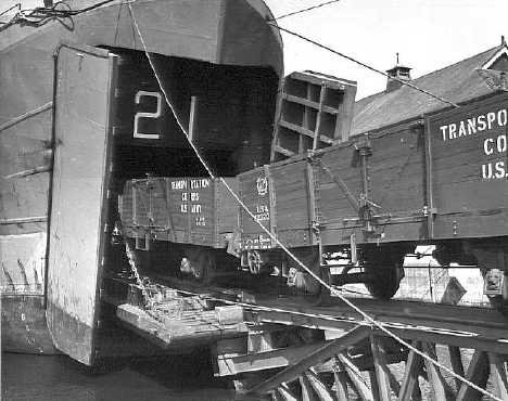 USS LST-21 loading railroad cars at Southhampton, England in June 1944 (Link)